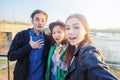 Group of Asian teens taking selfie on phone, having fun, best friends and digital generation concept Royalty Free Stock Photo