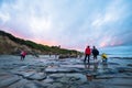 Group of asian tourist taking a photo at Moeraki Boulders, New Zealand. Beautiful landmark after sunset. Toursit landmark. I Royalty Free Stock Photo