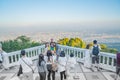 Group Asian tourists pose for photo at lookout at Wat Phra That