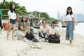 Group of asian volunteer make a cleaning sea beach out of a plastic litter