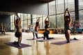 Group of Asian women and man doing pilates lying on yoga mats in aerobics class. Young sporty people on bended knee on Royalty Free Stock Photo