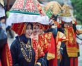 Group of Asian women wearing traditional minangkabau ethnic costume in wedding ceremony carrying offering goods on their head.