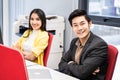 Group of Asian young business man and woman working on computer in office. Portrait of people in casual suit cross arm sitting on Royalty Free Stock Photo