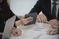 Group Asian Young Businessmen and woman discussing on stockmarket charts at office desk, they are business analyzing. used Royalty Free Stock Photo