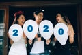 Group of asian young people holding balloon numbers 2020, Celebration New year concept