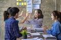 A group of Asian youths with a creative team leader. Have fun laughing Royalty Free Stock Photo