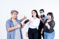 A group of Asians, men and women show signs of inviting use face mask