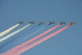 A group of assault plane Sukhoi Su-25 Grach NATO reporting name: `Frogfoot` in the sky smoke colors of Russian flag at the rehea