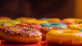 Group of assorted donuts. Chocolate, pink, yellow, green and red on colored background.