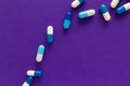 Group of assorted white and blue tablets. Purple background. Lin Royalty Free Stock Photo