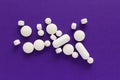 Group of assorted white tablets. Purple background. Royalty Free Stock Photo