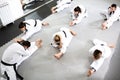 Group of athletes accompanied with physically challenged athlete preparing for a combat training workout Royalty Free Stock Photo