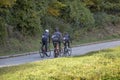 Group athletes cyclists riding a bike uphill