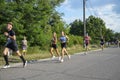 Group athletes runners men and women running city marathon competition