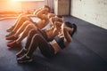 Group of athletic adult men and women performing sit up exercises Royalty Free Stock Photo