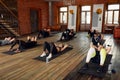 Group of athletic adult men and women performing sit up exercises to strengthen their core abdominal muscles at fitness Royalty Free Stock Photo