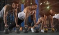 Group of Athletic Men Training Push Ups in Gym