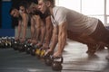 Group of Athletic Men Training Push Ups in Gym