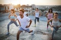 Group of athletic young people, friends in sportswear doing exercises. Sport outdoors Royalty Free Stock Photo