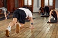 group of athletic young people in sportswear doing push ups or plank at the gym, group fitness concept Royalty Free Stock Photo