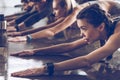 Group of athletic young people in sportswear stretching at the gym