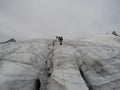 Group attached to rope going up a glacier