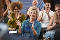 Group Attending Neighborhood Meeting Applauding Speaker In Community Center Royalty Free Stock Photo