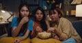 Group of attractive Asia lady girl freaking out fear and terrified moment eat popcorn watch horror online movie on couch in living