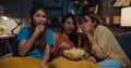 Group of attractive Asia lady girl freaking out fear and terrified moment eat popcorn watch horror online movie on couch in living