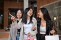 Group of attractive, fun Asian girls in trendy clothes are enjoying shopping in the city Royalty Free Stock Photo