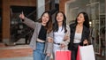 Group of attractive, fun Asian girls in trendy clothes are enjoying shopping in the city Royalty Free Stock Photo