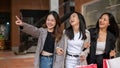 Group of attractive, fun Asian girls in trendy clothes are enjoying shopping in the city Royalty Free Stock Photo