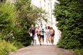 Group of attractive teenage students running from university. Royalty Free Stock Photo