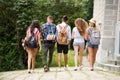 Group of attractive teenage students walking from university. Royalty Free Stock Photo