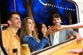 Group of attractive young friends choosing and buying different types of fast food in eat market in the street. Royalty Free Stock Photo