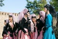 Group of attractive young girls in beautiful dresses meeting at event of city festival