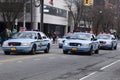A group of law enforcement vehicles drive along a road, Long Island, New York, USA