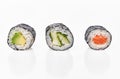 Group of avocado, salmon and cucumber sushi makis isolated on white background Royalty Free Stock Photo