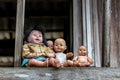 Group of baby dolls sitting on old wooden stairs