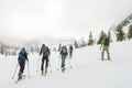 Group of back country skiers walking through a misty valley.