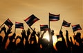 Group of Back lit People Waving Flag of Thailand