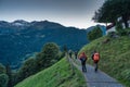 Group of backpacker hiking on trail in Swiss Alps valley on summit Royalty Free Stock Photo