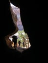 Group of backpackers hiking through a slot canyon