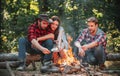 Group of backpackers relaxing near campfire. Friends spend leisure weekend forest nature background. Tourists relaxing Royalty Free Stock Photo