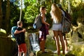 Group of backpackers in thailand looking at jungle waterfall