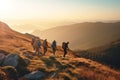 A group of backpackers walking through the mountains at sunset. Royalty Free Stock Photo
