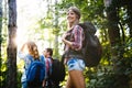 Group of backpacking hikers going for forest trekking Royalty Free Stock Photo