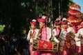 Group of Balinese men in traditional costumes play gamelan music