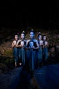 A Group of Balinese woman line up with the wooden mask in their hands while wearing a traditional dance costumes