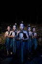 A Group of Balinese woman line up with the wooden mask in their hands while wearing a traditional dance costumes Royalty Free Stock Photo